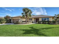 Single-story home with a landscaped lawn, attached garage, and attractive curb appeal at 4503 Coral Lake Dr, Bradenton, FL 34210