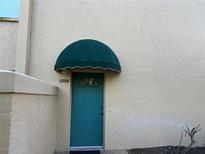 Teal front door with a green awning, featuring a window and address number 5505 at 5505 Ashton Lake Dr # 5505, Sarasota, FL 34231