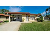 Inviting single-story home with carport and well-manicured lawn at 6405 Auburn Ave # 8, Bradenton, FL 34207