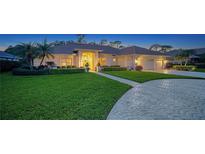 Charming single-story home with a well-manicured lawn and paved driveway at 7412 Links Ct, Sarasota, FL 34243