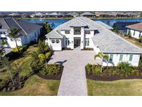 Luxury home with tile roof, paver driveway & lake view at 8497 Pavia Way, Bradenton, FL 34202