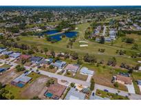 Community overview featuring houses, golf course, and a lake at 134 Rotonda Cir, Rotonda West, FL 33947