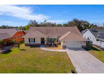 Aerial view of a single-Gathering home with a large yard and neighborhood at 207 Santarem Cir, Punta Gorda, FL 33983