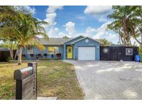 Cute bungalow with a yellow door, paver driveway, and fenced backyard at 2207 22Nd W St, Bradenton, FL 34205