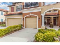 Two-story townhome with double garage and landscaped front at 284 Crew Ct, Sarasota, FL 34243