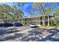 Two-story condo building with ample parking and lush landscaping at 3011 Quail Holw # 3011, Sarasota, FL 34235