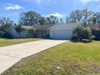 Single-story house with attached garage and well-manicured lawn at 3950 Sawyerwood Rd, Sarasota, FL 34233