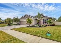 Two-story house with landscaping, driveway, and sidewalk at 6428 Devesta Loop, Palmetto, FL 34221