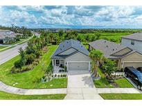 Aerial view of a single-Gathering home with a landscaped yard and neighborhood view at 8250 Velda Trl, Sarasota, FL 34241