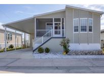 Charming single-Gathering home with a covered carport, front porch and manicured landscaping at 10315 Cortez W Rd # 5H, Bradenton, FL 34210