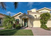 Beautiful 2 story home with lush landscaping and a brick paved driveway at 1152 Beachcomber Ct # 15, Osprey, FL 34229