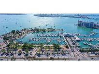 Expansive aerial view of a marina showcasing numerous boats and yachts with waterfront condo buildings in the background at 1350 Main St # 1410, Sarasota, FL 34236