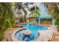 Inviting pool with patio and tropical landscaping at 203 69Th St # A, Bradenton Beach, FL 34217