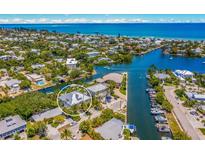 Aerial view of waterfront home with private dock, showcasing a desirable location and water access at 238 Oak Ave, Anna Maria, FL 34216