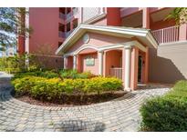 Inviting building entrance with landscaped grounds at 5250 Manorwood Dr # 4A, Sarasota, FL 34235