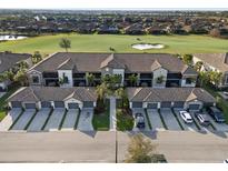 Beautiful aerial view of a condo building overlooking a golf course with lush landscaping and a manicured lawn at 5527 Palmer Cir # 205, Bradenton, FL 34211