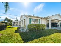 White single story home with carport and well manicured lawn at 6091 Coral Way, Bradenton, FL 34207