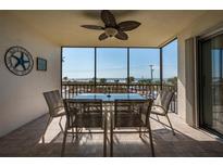 Relax on this tiled lanai with a ceiling fan and views of the beach at 757 Beach Rd # 300, Sarasota, FL 34242