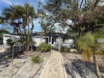 Cute bungalow with a landscaped front yard and walkway at 1903 Oak St, Sarasota, FL 34236