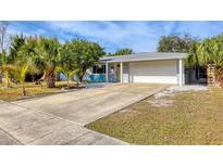 Bright, charming home with a large driveway and tropical landscaping at 2503 Bispham Rd, Sarasota, FL 34231