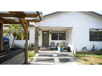 Modern white house with a landscaped front yard and paved driveway at 2606 19Th St, Sarasota, FL 34234