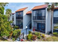 Inviting condo building with lush landscaping and a walkway at 3275 Beneva Rd # 104, Sarasota, FL 34232