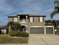 Two-story house with a large driveway and landscaped yard at 6150 42Nd Street E Cir, Bradenton, FL 34203