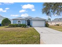 One-story house with light blue exterior, two-car garage, and well-maintained lawn at 7432 39Th E Ct, Sarasota, FL 34243