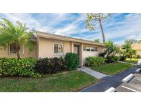Attractive exterior of condo with well-maintained landscaping at 2782 Woodgate Ln # 18, Sarasota, FL 34231