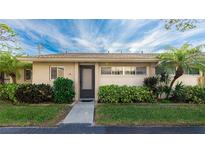 Condo building exterior showcasing landscaping and entrance at 2782 Woodgate Ln # 18, Sarasota, FL 34231
