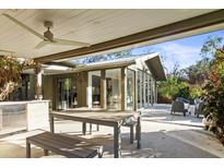 Outdoor patio with seating area, dining table, and built-in grill at 3439 Tobero Ln, Sarasota, FL 34235
