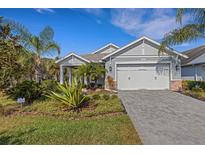 Beautiful one-story home with a two-car garage and landscaped yard at 8018 Sandstar Way, Sarasota, FL 34240