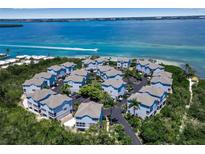 Aerial view of a waterfront community with numerous houses at 821 Evergreen Way, Longboat Key, FL 34228