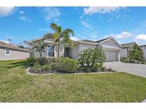 Single-story home with landscaped yard, two-car garage, and attractive curb appeal at 8612 Sundance Loop, Sarasota, FL 34238