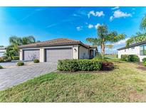 Charming single-story home featuring a two-car garage, tile roof, and well-maintained landscaping at 15917 Clear Skies Pl, Lakewood Ranch, FL 34211