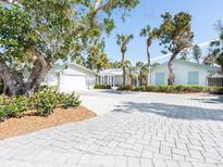 Attractive home with a large, paved driveway and lush landscaping at 18 N Casey Key Rd, Osprey, FL 34229