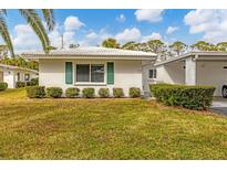 Single story home with green landscaping and carport at 1815 Vera Pl # 9, Sarasota, FL 34235