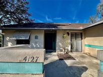 Inviting exterior with teal accents and well-maintained landscaping at 4127 3Rd Ave W, Palmetto, FL 34221