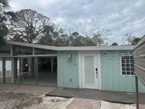 Light teal single story home with a deck and walkway at 4510 Banan Pl, Sarasota, FL 34242