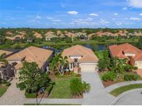 Aerial view of a beautiful home in a desirable neighborhood with a lake at 531 Latitude Ln, Osprey, FL 34229
