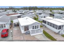 Aerial view of a mobile home community, featuring a single-wide mobile home with a carport and deck at 3333 26Th E Ave # 1120, Bradenton, FL 34208