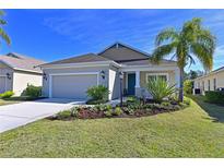 Attractive single-story house with a two-car garage and landscaped front yard at 11924 Forest Park Cir, Lakewood Ranch, FL 34211