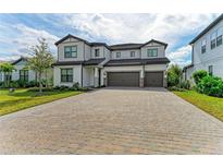 Two-story house with three-car garage and paver driveway at 16446 Slate Pl, Bradenton, FL 34211