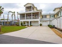 Two-story house with a large driveway and a screened porch at 220 82Nd St, Holmes Beach, FL 34217