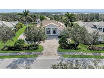 Luxury home with circular driveway, landscaping, and inviting entryway at 3360 Founders Club Dr, Sarasota, FL 34240