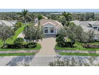 Stunning front exterior of a house showcasing the driveway, landscaping, and architectural details at 3360 Founders Club Dr, Sarasota, FL 34240