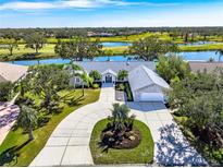 Luxury home on golf course with circular driveway and lake view at 3520 Wilderness W Blvd, Parrish, FL 34219