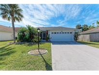 Single story home with attached garage, landscaping, and driveway at 4410 70Th E Dr, Sarasota, FL 34243