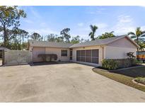 House exterior features a two-car garage and a large driveway at 6824 Jarvis Rd, Sarasota, FL 34241