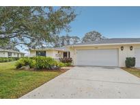 Updated single-story home with a two-car garage and landscaped yard at 7157 Fairway Bend Cir, Sarasota, FL 34243